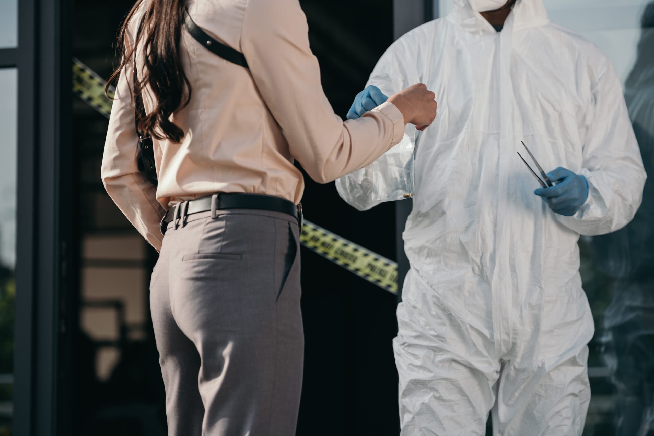 Forensic investigator and detective at a scene - forensic DNA testing